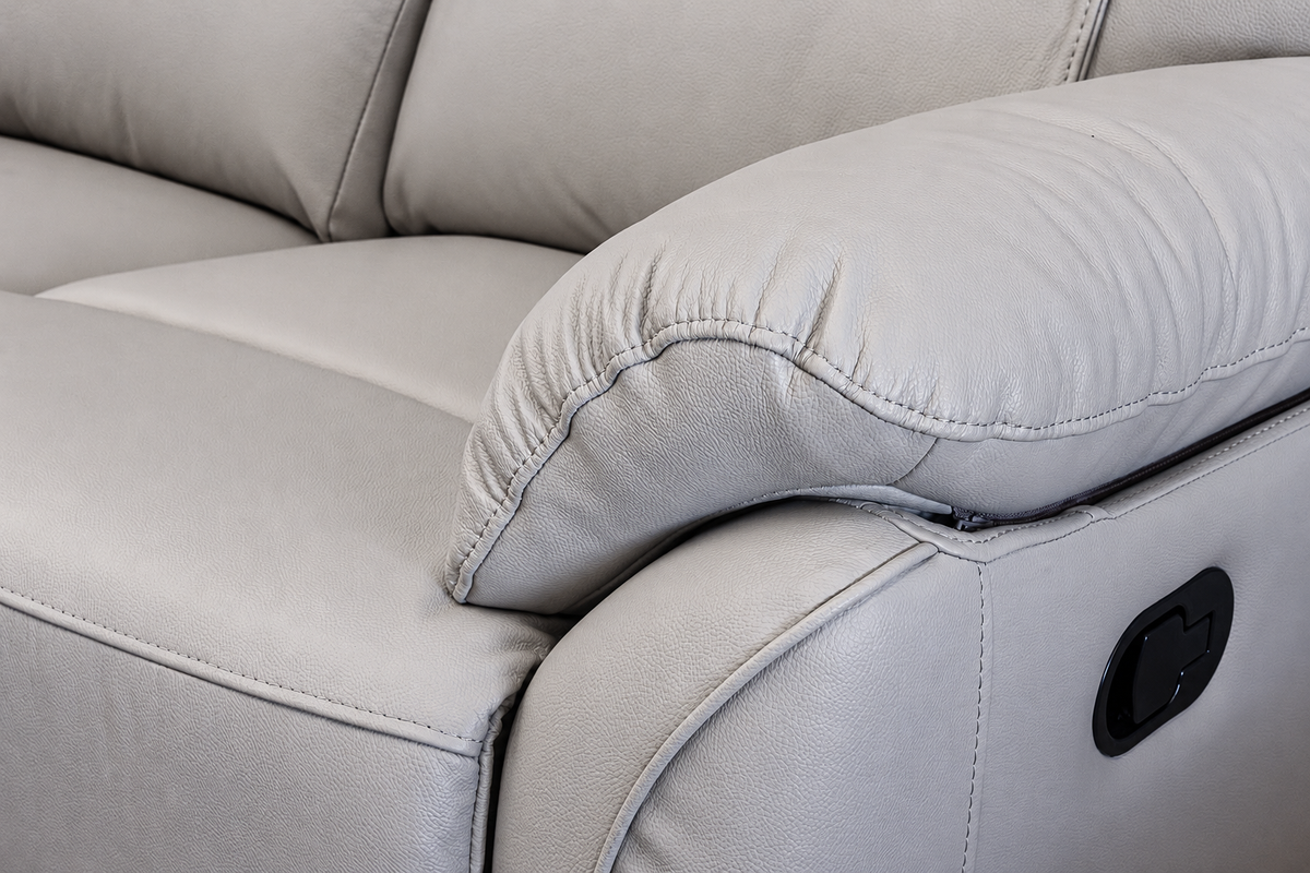 Close-up of a light gray upholstered recliner chair 